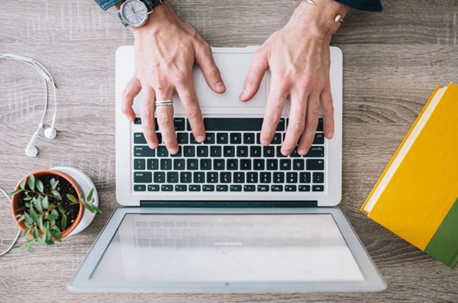 Freiberufler tippt am Laptop zur Umsatzsteuervoranmeldung für Freiberufler.